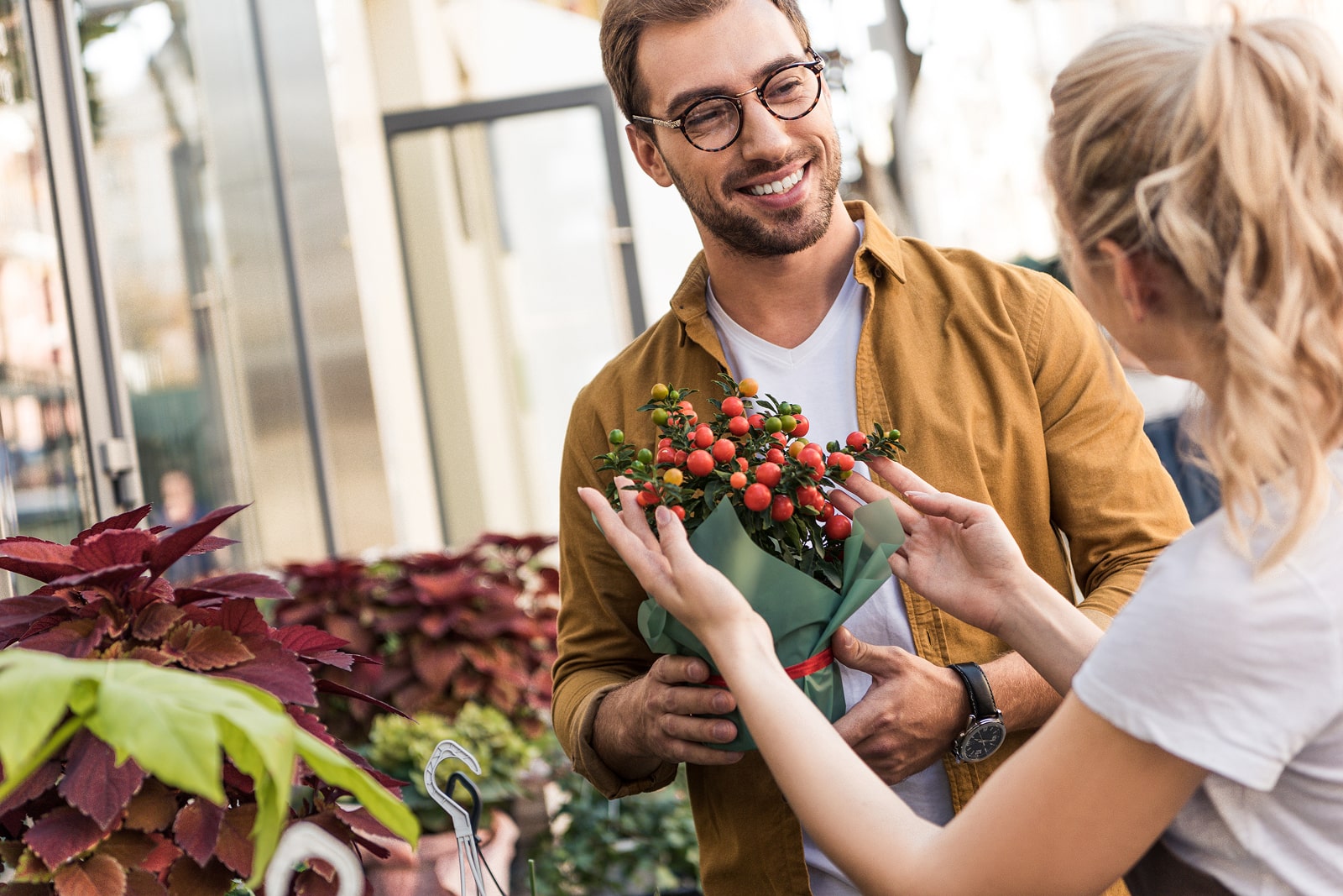 Smiling couple with flowers at a market, flowers theme